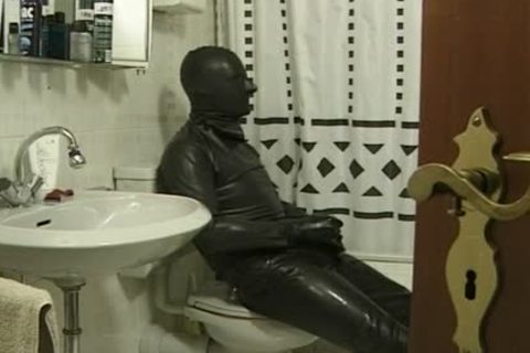 dude In dark Latex Catsuit Jacks Off In bathroom