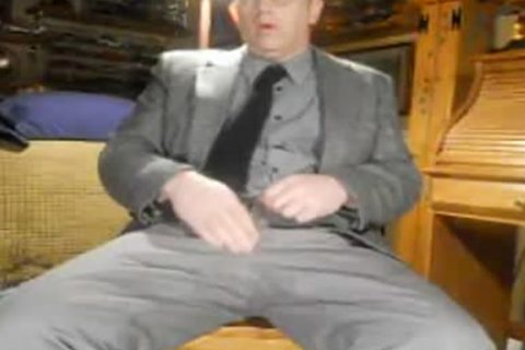 Mature wearing suit having fun with balls daddy