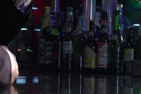 Two males In Suits Meet In A Bar