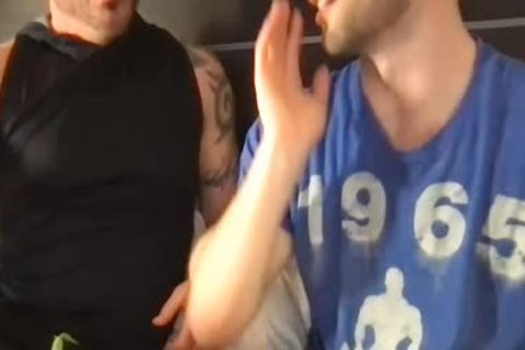 Two fashionable males giving a kiss And Touching Each Other's weenies