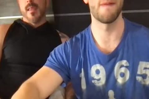 Two fashionable males giving a kiss And Touching Each Other's weenies