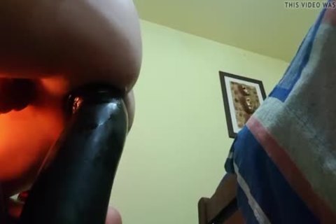 Riding giant black dildo