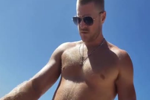 darksome And White gay On A Public Beach. Interracial Outdoor