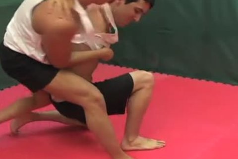 Wrestlers fight & blow each otthis fellowr in tthis fellow ring